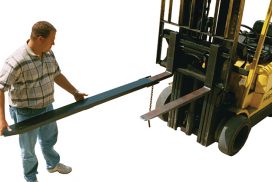 Fork extensions being installed on Forklift forks