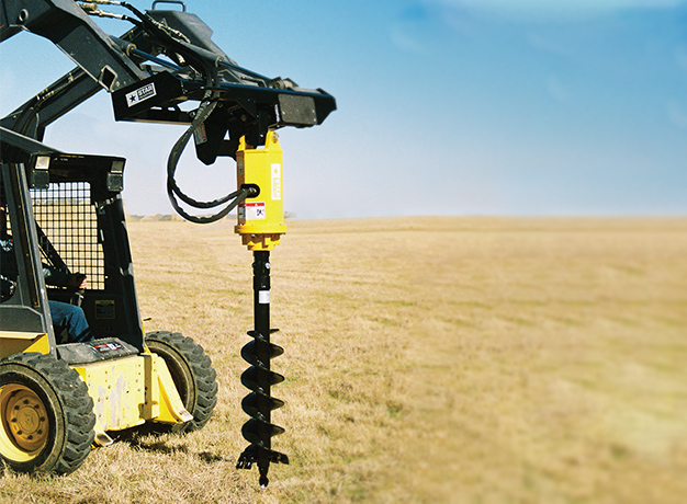 Heavy duty auger attached to skid steer